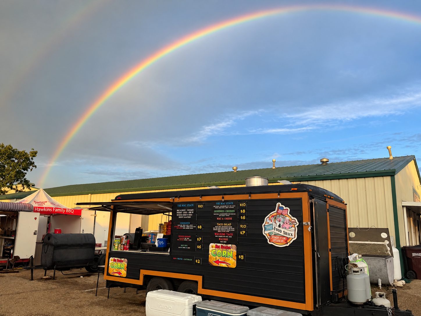 The TMay's trailer parked under a rainbow