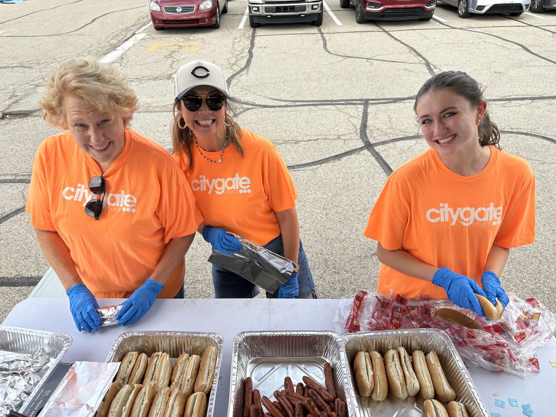 Volunteers serving hot dogs