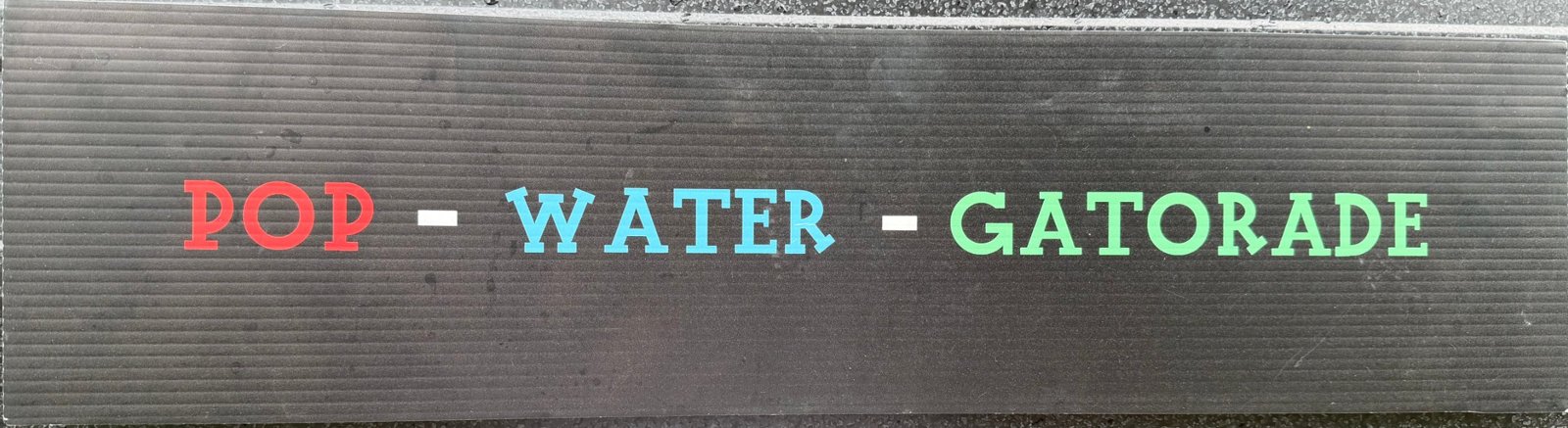 Menu sign: Drinks — pop, water, Gatorade
