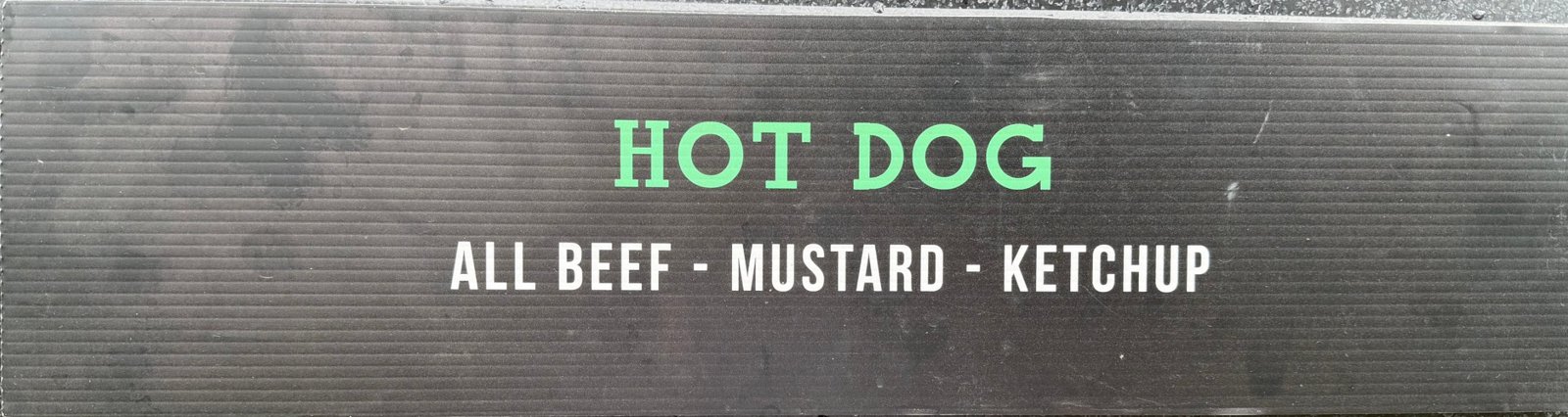 Menu sign: Hot Dog — all beef, mustard, ketchup