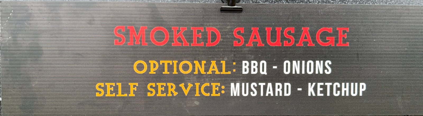 Menu sign: Smoked Sausage — optional BBQ and onions; self-serve mustard and ketchup